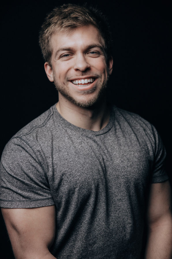 person with a gray shirt with a black background